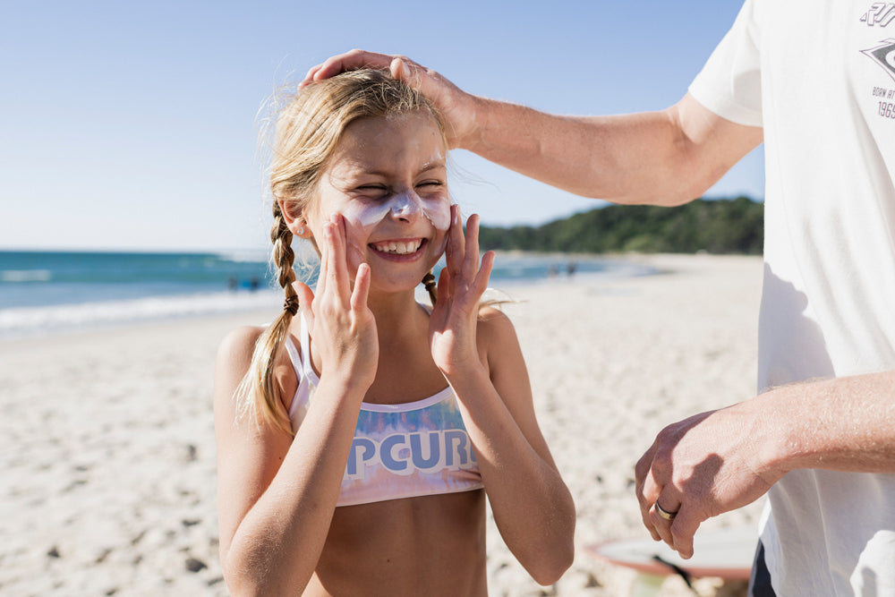 Grom putting on sunscreen