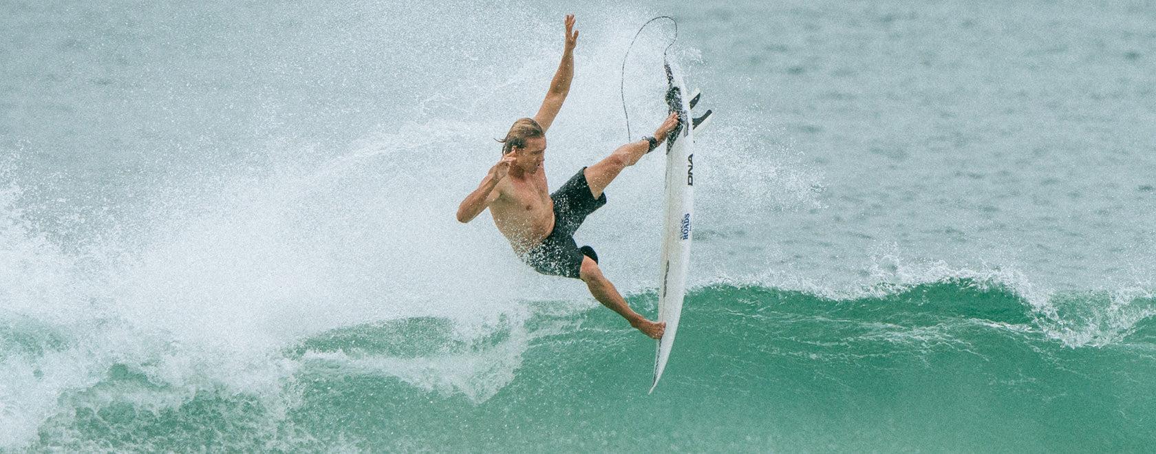 Surfer riding a wave on a surfboard in the ocean