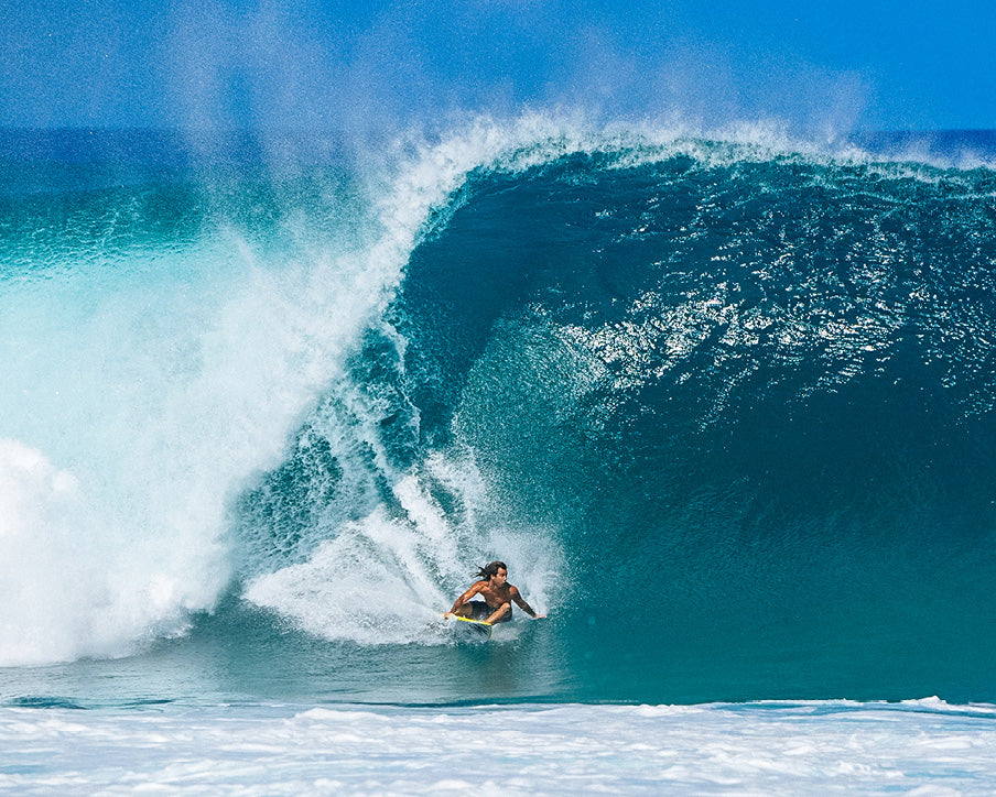 Surfer riding a large wave in the ocean