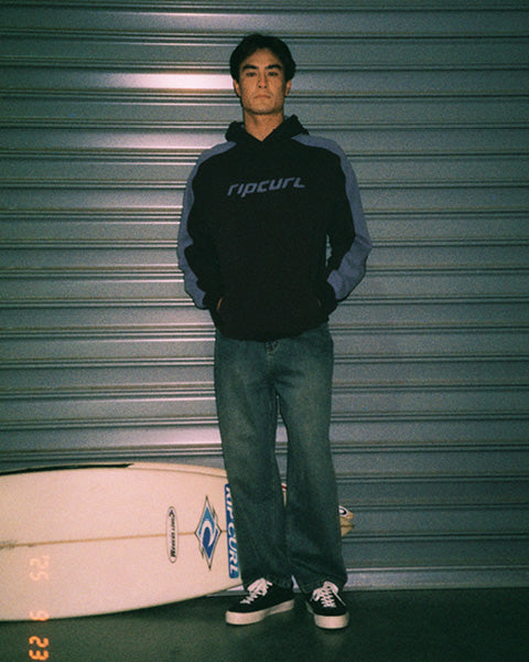 Model wears black and blue archive hoodie