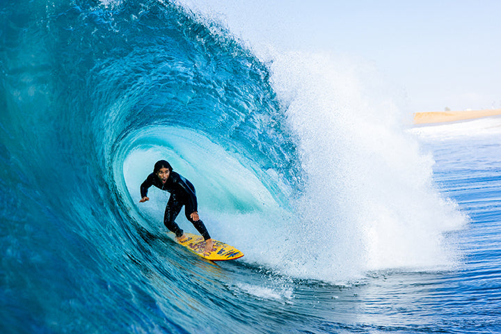 Surfer riding a large wave in the ocean